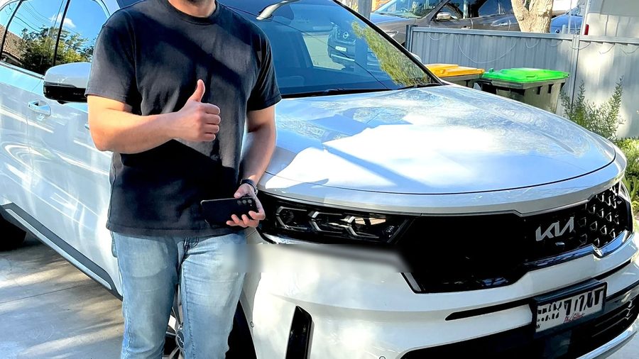 Customer with the Kia Sorento they sold to CarBuyers
